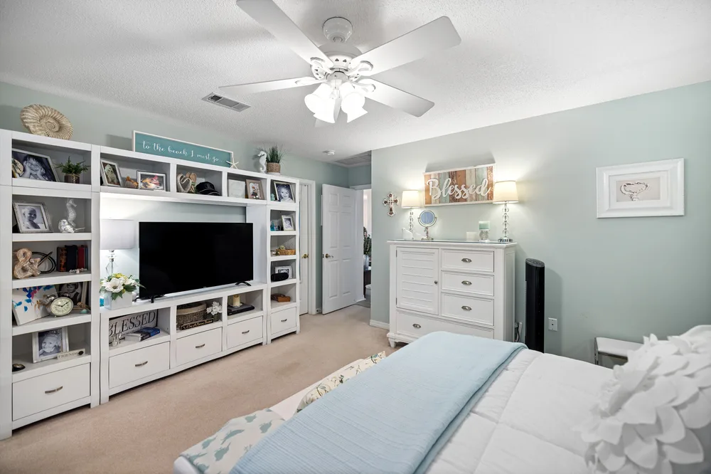 Bedroom with media setup design by Joy Signature Designs